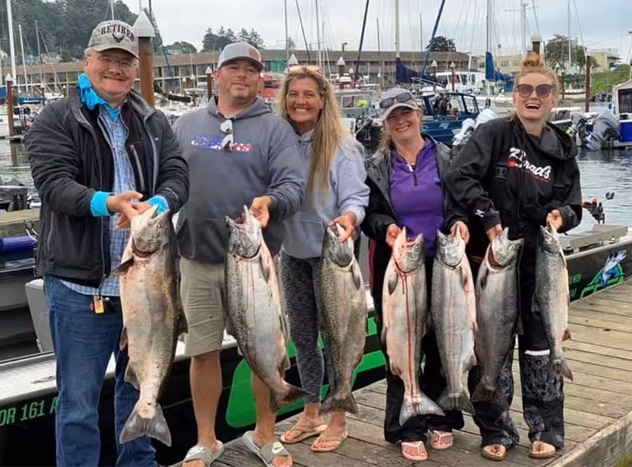 salmon-group2 A family of people proudly holding up their fish caught with the help of Columbia River fishing guides
