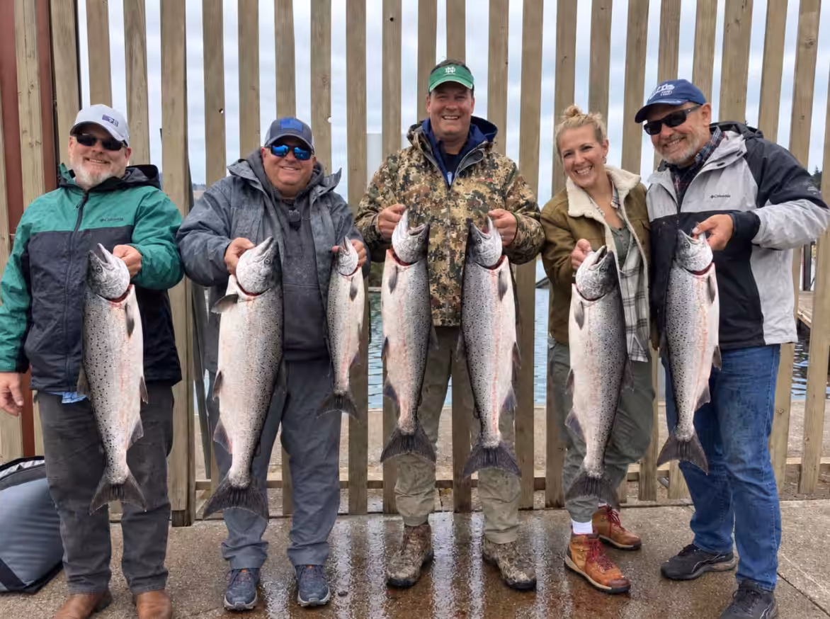 Anglers celebrating their catch after a tough Columbia River salmon fishing day
